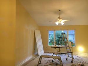 A bright room featuring yellow walls and a ceiling fan, creating a warm and inviting atmosphere.