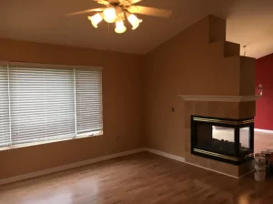 A cozy living room featuring a fireplace and elegant hardwood floors, creating a warm and inviting atmosphere.